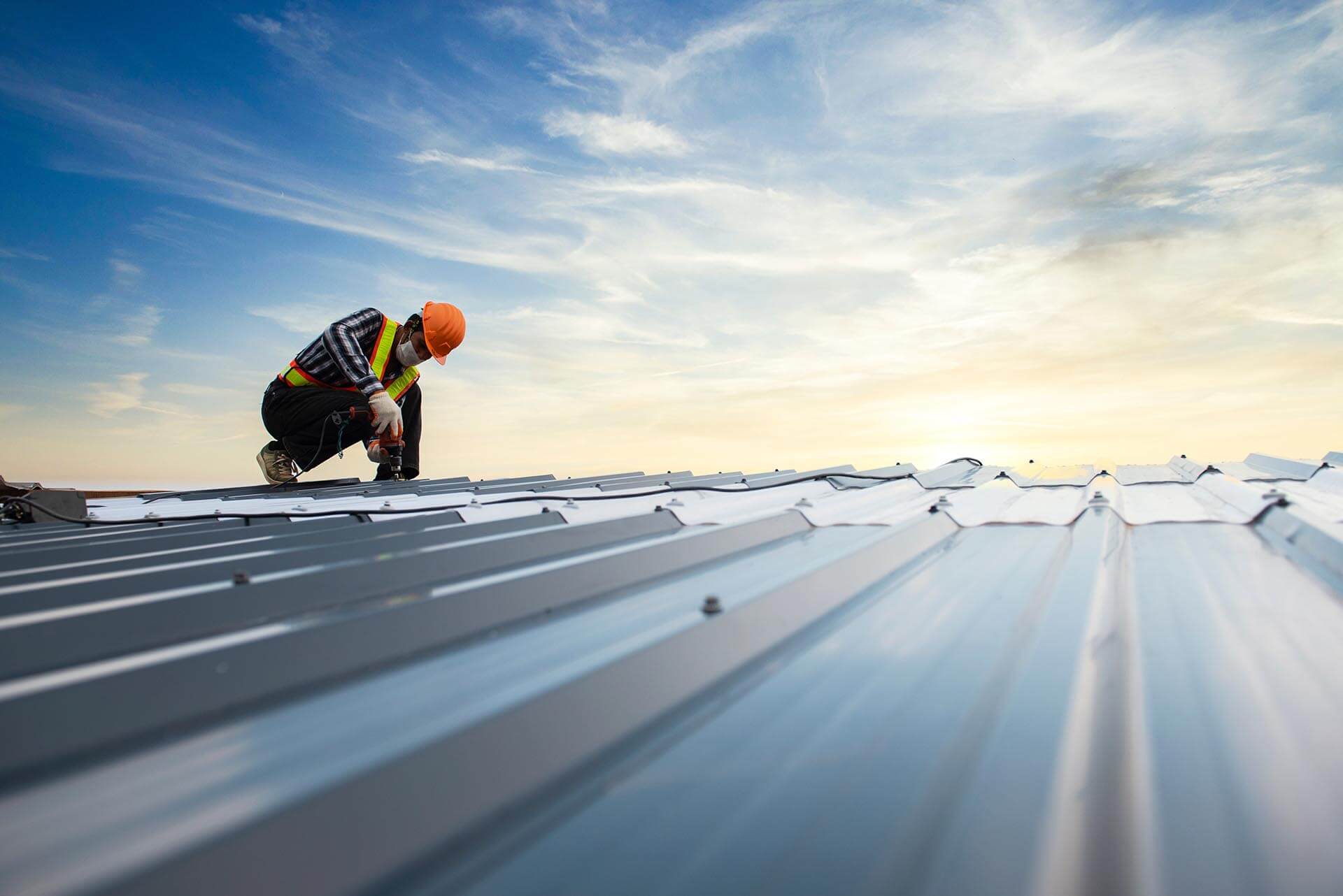 Alpha Roofing Commercial Roofing Kamloops – certified roofer installing commercial metal roofing system on industrial building in Kamloops BC